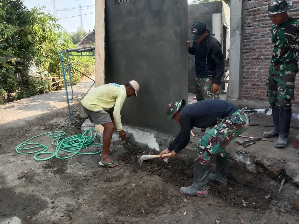 Warga dan Satgas TMMD Ratakan Pondasi untuk MCK di Masjid Parangjoro